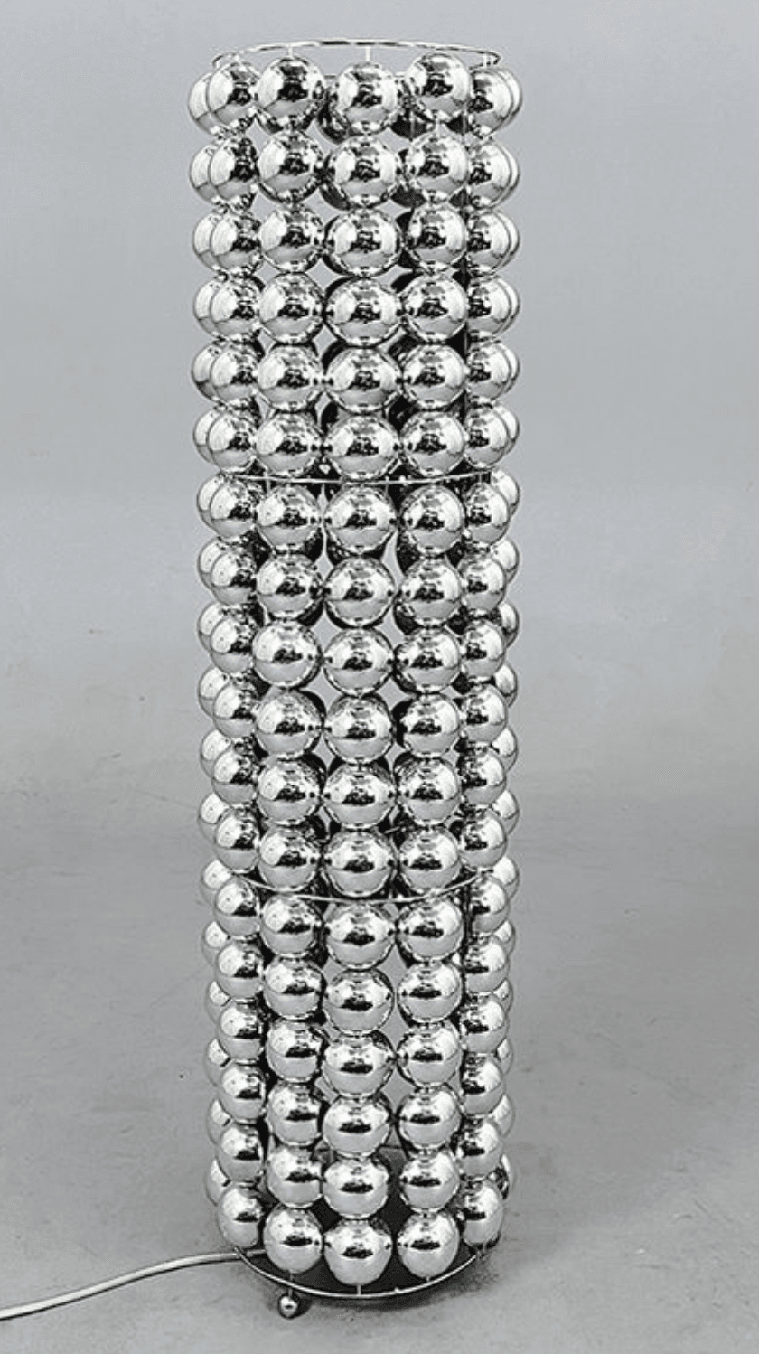 A floor lamp with a cylindrical shade constructed from multiple rows of spherical, reflective elements. The spherical elements are arranged in a grid pattern, attached to an internal wireframe. The base appears to be metal, with small feet. A power cord is visible extending from the base. — 3D model