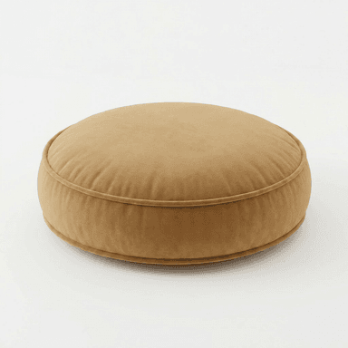 A circular, thick floor cushion upholstered in a soft, golden-brown velvet-like fabric. It features piping around its circumference on both the top and bottom edges, defining its plush, structured shape. The cushion is designed for comfortable, low-level seating or as a footrest. — 3D model