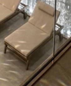 An outdoor chaise lounge made of wood with cream-colored cushions and wheels for portability. The backrest is adjustable, and it includes a headrest cushion. — 3D model