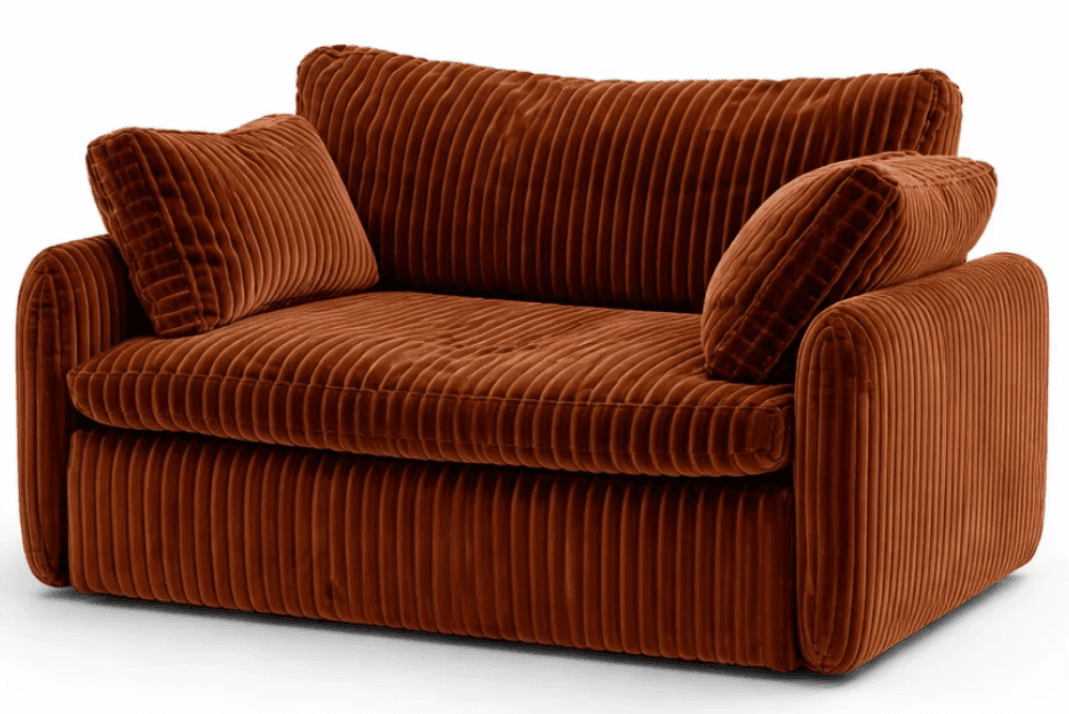 A compact two-seater loveseat, fully upholstered in a burnt orange corduroy fabric with a distinct ribbed texture. It features plush, deep seating cushions, wide padded armrests, and two matching loose back cushions, providing a soft and inviting aesthetic. The design suggests a modern or contemporary style with an emphasis on comfort. — 3D model