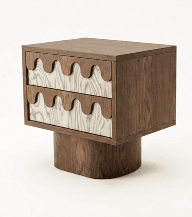 A contemporary nightstand featuring two drawers with a distinctive wave-like carved wooden facade. The main body and base are constructed from dark wood, while the drawer fronts exhibit a contrasting lighter wood with prominent grain patterns, also featuring the wave motif. The piece is supported by a solid, cylindrical wooden base. — 3D model