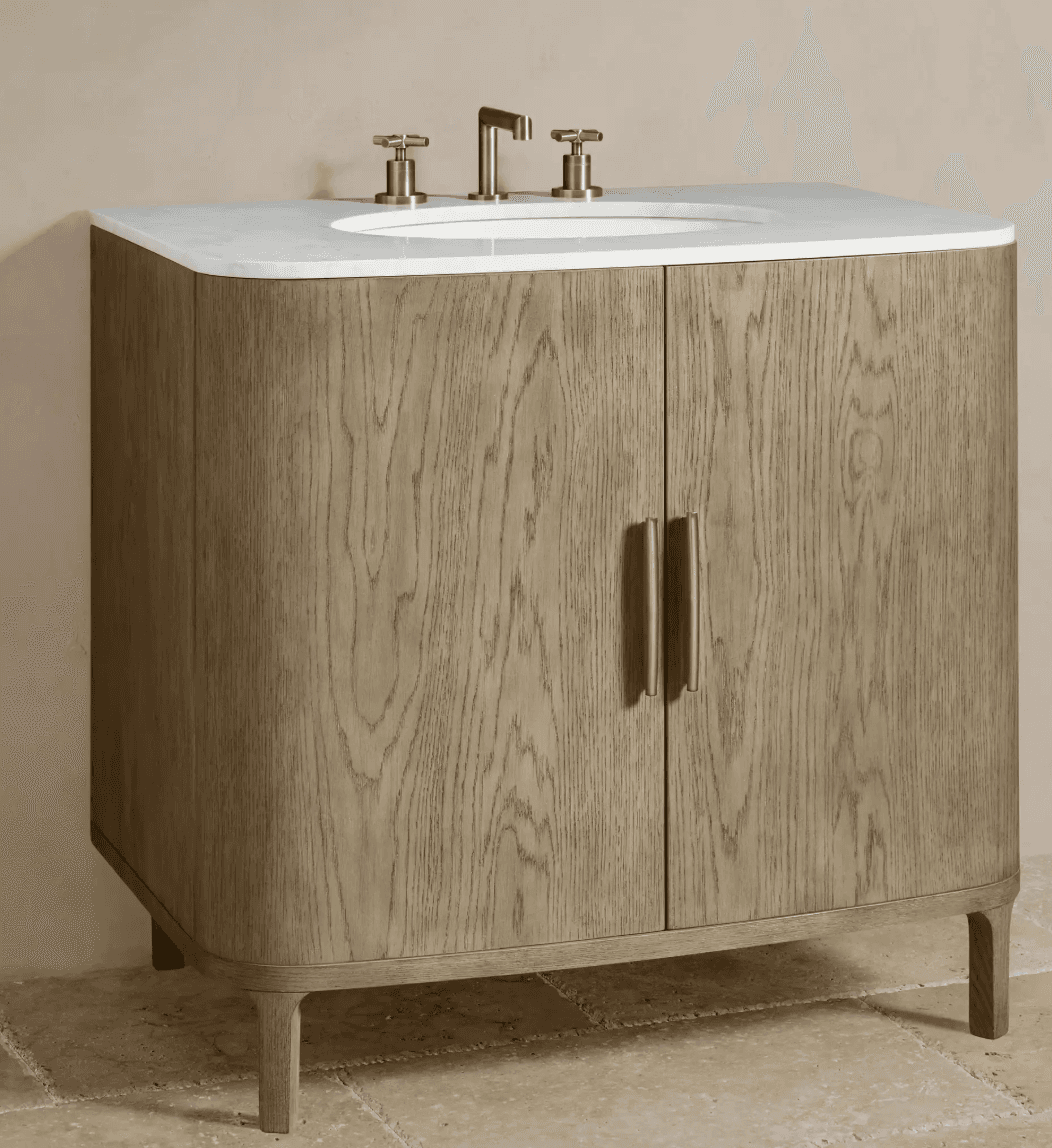 A contemporary bathroom vanity featuring a white countertop with an integrated sink, a wooden cabinet with curved front panels, and two doors. It is supported by four tapered legs. The vanity is equipped with brass-colored faucets and handles. — 3D model