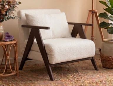 A modern lounge chair featuring a prominent dark wood frame and plush, off-white bouclé upholstery. The chair includes a loose back cushion for added comfort, and its design emphasizes clean lines and a relaxed aesthetic. — 3D model
