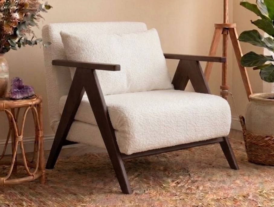 A modern lounge chair featuring a prominent dark wood frame and plush, off-white bouclé upholstery. The chair includes a loose back cushion for added comfort, and its design emphasizes clean lines and a relaxed aesthetic. — 3D model