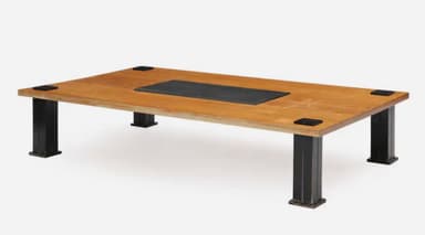 A rectangular coffee table featuring a light-toned wooden top with a central, recessed black inlay. The table is supported by four robust, square-sectioned black metal legs, which are visibly attached to the tabletop with square black metal corner brackets. — 3D model