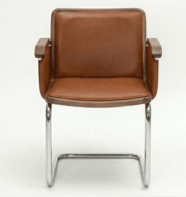 A cantilever armchair featuring a tubular chrome-plated steel frame. The seat, backrest, and armrests are upholstered in brown leather. The armrests also incorporate wooden accents, likely walnut, adding a touch of warmth and contrast to the metal and leather. — 3D model