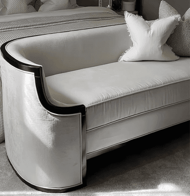 A sophisticated two-seater loveseat featuring a continuous, rounded back and integrated armrests, upholstered in a pristine white fabric. The entire silhouette is accentuated by a bold, black contrasting trim that outlines its elegant curves and base, giving it a distinctive Art Deco or contemporary aesthetic. — 3D model