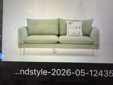 A modern two-seater sofa upholstered in a light green fabric, featuring clean lines, low track arms, and slender light-colored metal legs. It includes two back cushions, two seat cushions, and one decorative throw pillow with text. — 3D model