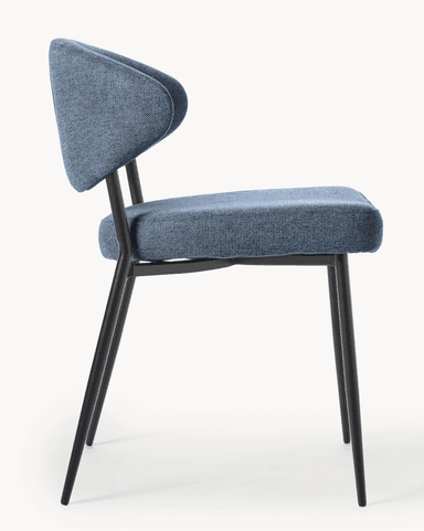 A contemporary dining chair featuring a blue upholstered seat and a distinctively curved, armless backrest. The chair is supported by four slender, tapered black metal legs. — 3D model