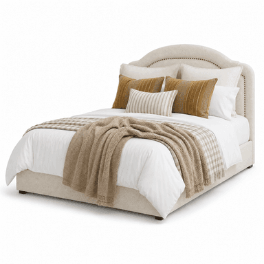 An upholstered platform bed featuring an arched headboard with decorative nailhead trim along the edges. The entire frame is covered in a light beige, textured fabric, supported by dark, short legs. The bed is dressed with white bedding and layered with neutral and mustard-colored decorative pillows and throws. — 3D model
