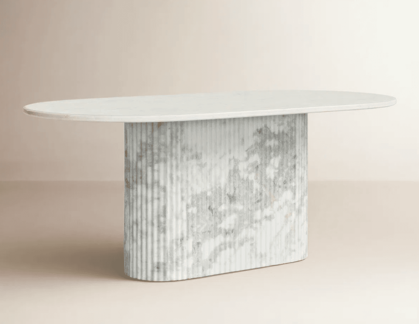 A contemporary dining table featuring an oval white marble tabletop supported by a substantial fluted pedestal base made of grey and white veined marble. The base has a rounded, pill-like shape, complementing the oval top. — 3D model