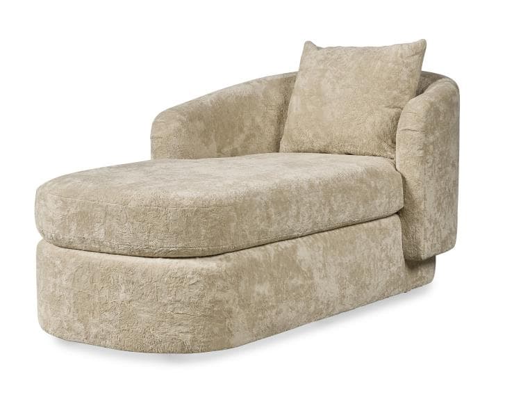 A contemporary chaise lounge upholstered in a light beige, textured fabric, featuring a single armrest, rounded forms, and an integrated base, accompanied by a matching throw pillow. — 3D model