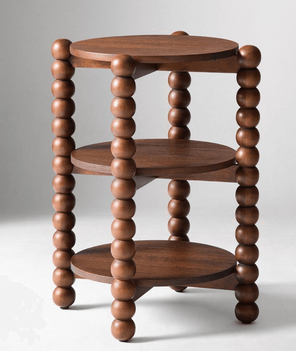 A three-tiered side table with round shelves supported by vertical posts. Each post is constructed from a series of stacked wooden beads, giving it a distinctive bobbin leg appearance. The shelves are circular and appear to be made of wood, with a visible grain. — 3D model