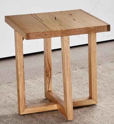 A contemporary end table constructed from wood. It features a solid, rectangular top with visible wood grain and some natural imperfections. The base consists of four upright wooden legs connected by a lower, intersecting stretcher for stability. The design is minimalist and showcases the natural texture and color of the wood. — 3D model