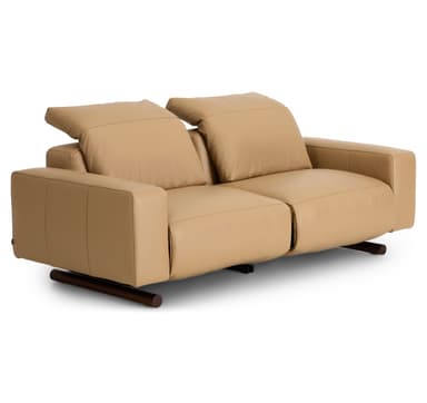 A modern two-seater reclining sofa, upholstered in smooth, light tan leather. It features two individual seats, each with a plush back cushion and integrated armrests. The sofa stands on small, dark-colored cylindrical feet, offering a minimalist profile. — 3D model