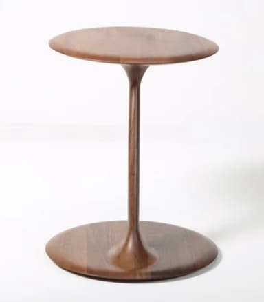 A minimalist pedestal side table crafted from dark wood, featuring a circular top and a flared, circular base connected by a slender central column. — 3D model