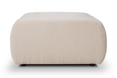 A rectangular ottoman with rounded edges.  The ottoman appears to be upholstered in a thick, plush, off-white or cream-colored fabric with a slightly textured surface, suggesting a bouclé or similar material.  Small, dark-colored feet are visible at the bottom. The overall shape is relatively low and wide. — 3D model