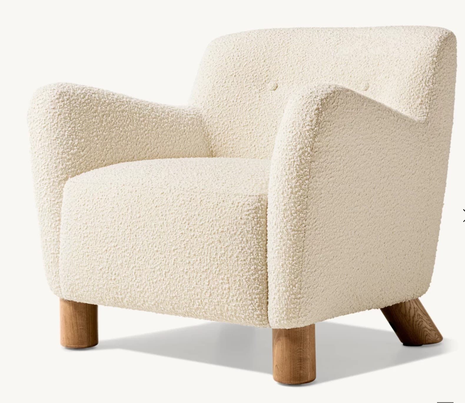 A contemporary armchair upholstered in cream-colored bouclé fabric, featuring a rounded silhouette, integrated arms, and wooden legs. — 3D model