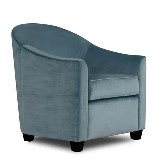 A contemporary upholstered accent chair with a rounded back and integrated arms, featuring a soft velvet-like fabric in a dusty blue color and supported by short, dark tapered feet. — 3D model
