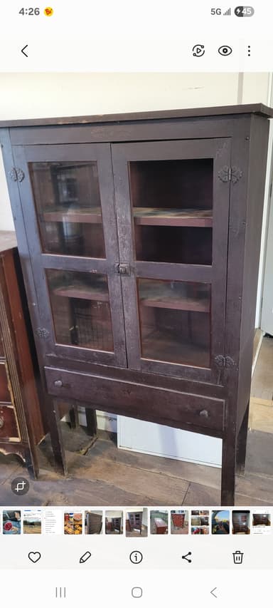 A tall, dark brown wooden display cabinet featuring two upper glass-paneled doors, a single lower storage drawer, and supported by four straight legs. The cabinet has a traditional design with simple lines and dark, possibly antique-finished hardware. — 3D model