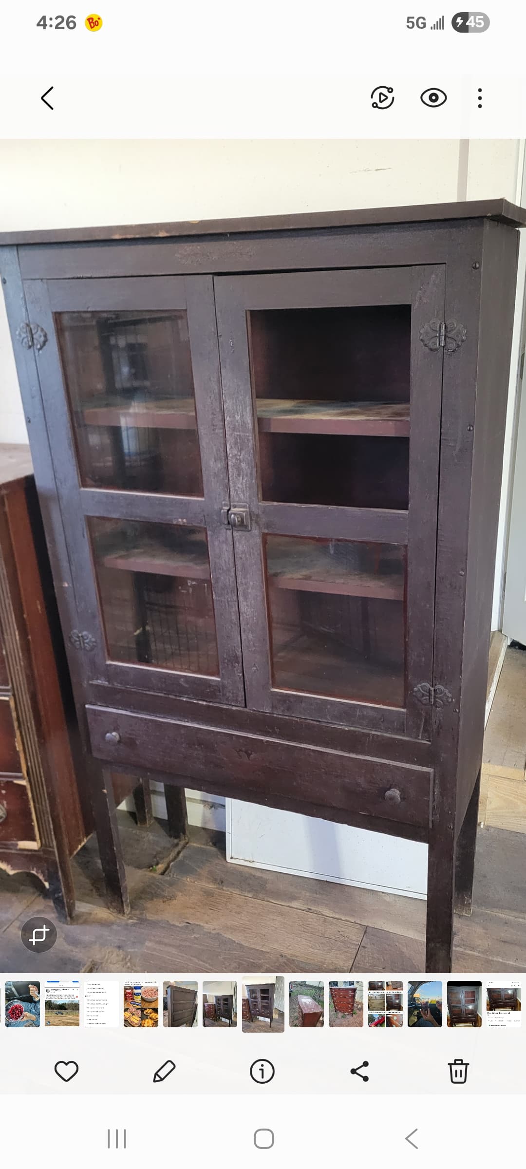 A tall, dark brown wooden display cabinet featuring two upper glass-paneled doors, a single lower storage drawer, and supported by four straight legs. The cabinet has a traditional design with simple lines and dark, possibly antique-finished hardware. — 3D model