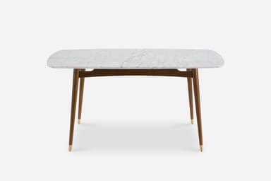 A rectangular dining table with a marble top and wooden legs. The marble top features a white base with grey veining, and its edges are rounded. The table has four tapered legs made of dark wood, each capped with a brass accent at the bottom. A wooden frame connects the legs beneath the tabletop. — 3D model