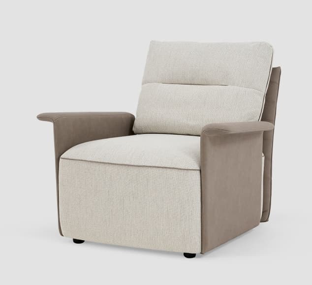 A contemporary armchair featuring a robust, upholstered form. The main seating surfaces, including the seat and backrest, are covered in a light beige or cream textured fabric, while the outer side panels and armrests are upholstered in a contrasting smooth, darker taupe or grey-brown material, likely faux leather or leather. The backrest is divided into two plush sections, and all upholstered edges are finished with precise piping in a matching darker tone. The chair sits on low-profile black feet. — 3D model