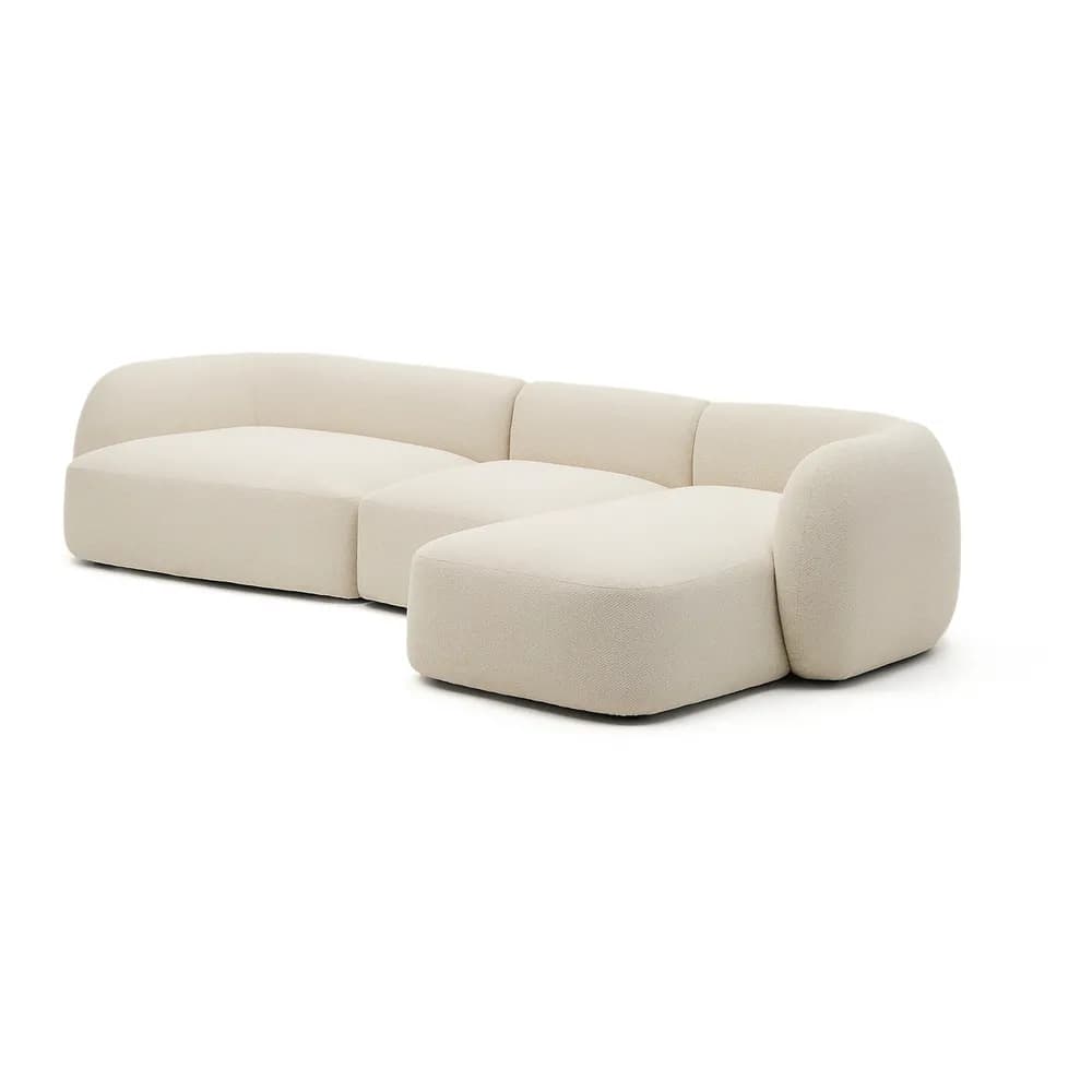 A contemporary, modular sectional sofa with a chaise lounge, upholstered in a light beige or off-white bouclé fabric. It features a low-profile design with soft, rounded edges and no visible legs, emphasizing comfort and a sleek, modern aesthetic. — 3D model