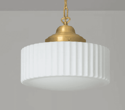 A close-up view of a ceiling-mounted pendant light featuring a brass canopy and suspension chain, connected to a circular, ribbed white opal glass shade. The shade has vertical fluting around its perimeter, softening the light output. — 3D model