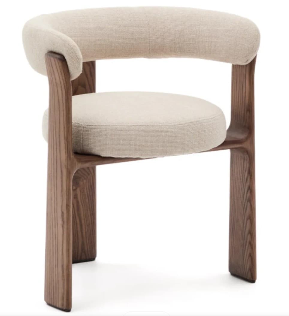 A contemporary armchair featuring a solid wood frame with a dark brown finish and light-colored upholstered seat and backrest. The backrest curves seamlessly into armrests, creating a unified, enveloping form. The seat is round and cushioned, and the legs are thick and integrated into the overall frame design. — 3D model