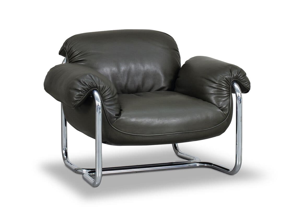 A single armchair with a low profile and plush upholstery. The frame is constructed from polished chrome tubing, forming a cantilevered base and armrests. The seat and back cushions are generously padded and covered in dark gray leather, exhibiting slight creasing indicative of soft material. — 3D model
