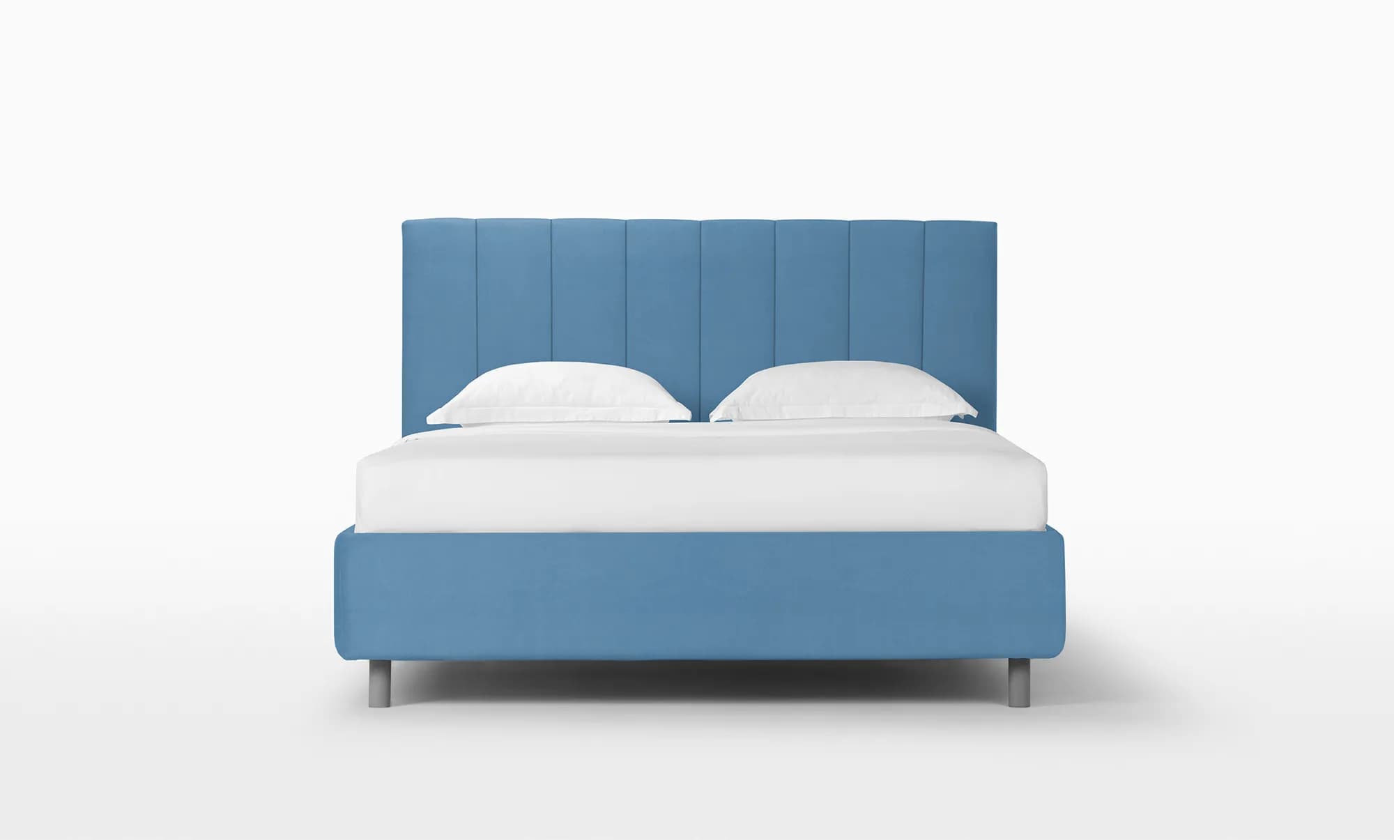 A modern platform bed featuring a tall, upholstered headboard with vertical channel tufting, and a matching upholstered bed frame. The entire bed is covered in a soft dusty blue fabric and rests on short, cylindrical metal legs. — 3D model