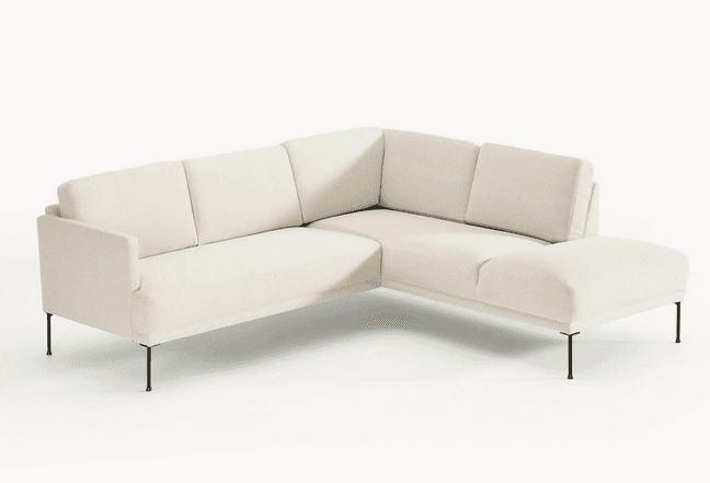 A modern sectional sofa with clean lines and a low profile. It features a light-colored, textured fabric upholstery and is supported by slender, dark-colored legs. The configuration appears to be an L-shape with a chaise extension. — 3D model