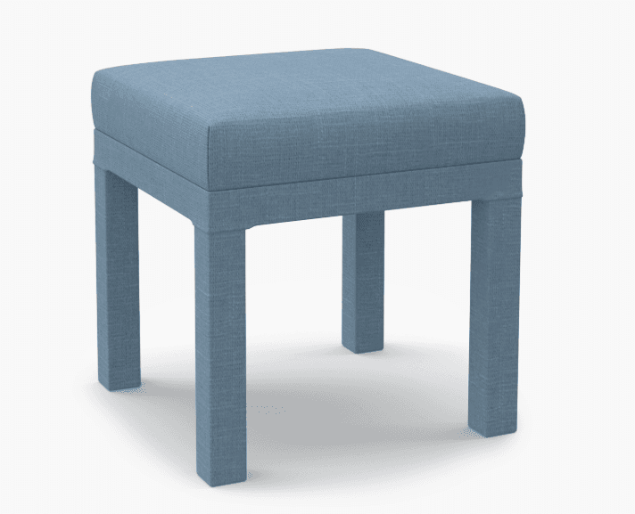 A square upholstered ottoman with four straight legs. The ottoman is covered in a textured blue fabric and has a minimalist design. — 3D model