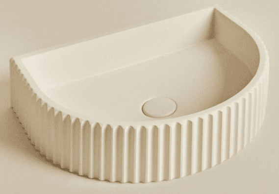 A countertop sink with a semi-circular basin and a decorative fluted exterior. The sink features a central drain opening. — 3D model