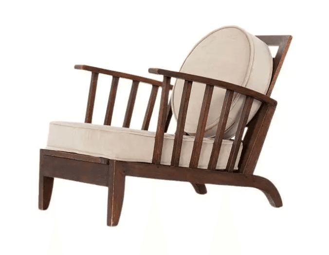 A wooden armchair with a high slatted back and a rounded cushion. The armchair features a dark wood frame with a lighter fabric upholstery on the seat and back cushion. The design is characterized by its minimalist structure and the use of vertical slats for the backrest. — 3D model