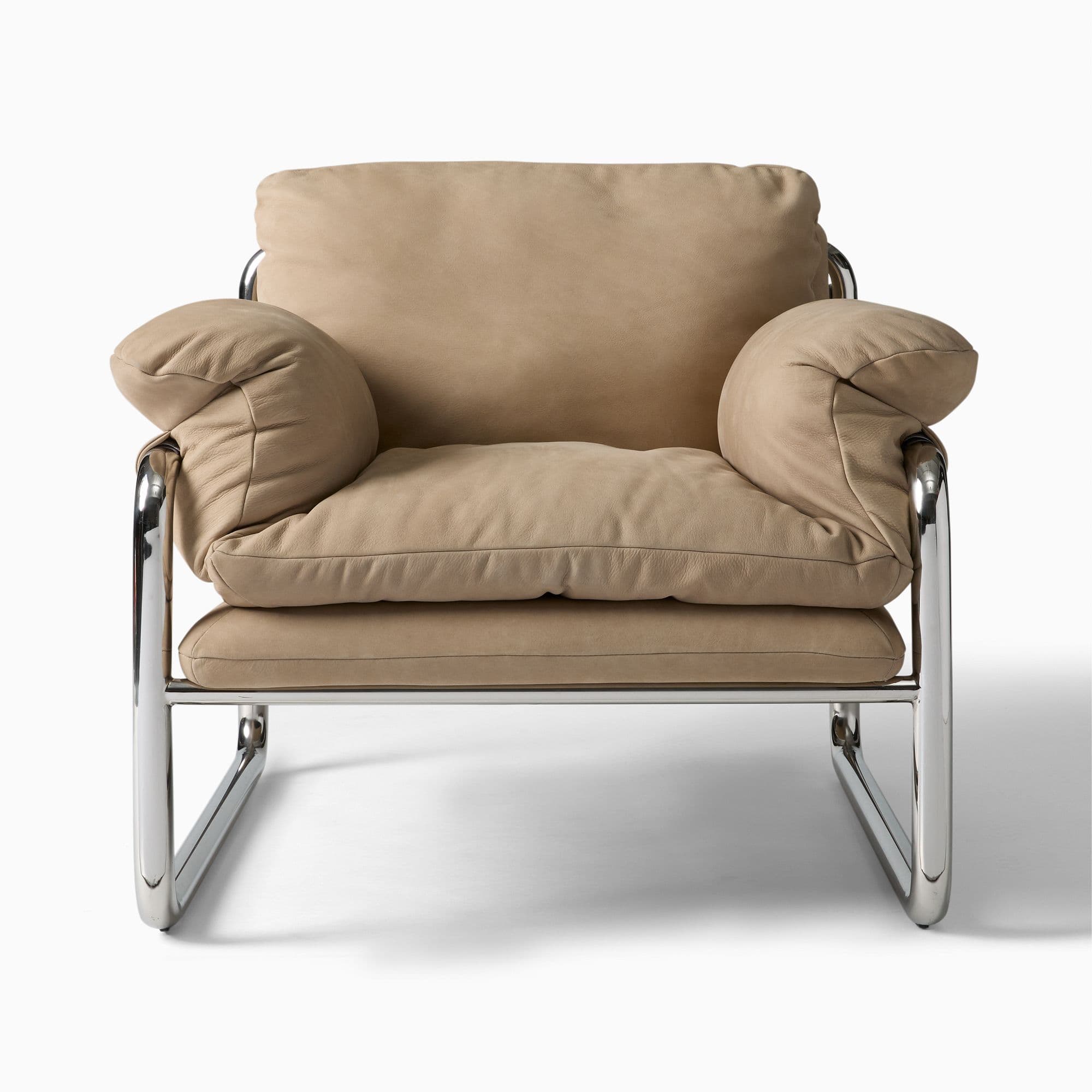 A plush armchair featuring a tubular chrome-plated steel frame and thick, upholstered cushions in a neutral beige tone. The armchair has a distinct modern design with soft, rounded armrests and a high back. The cushioning appears to be filled for comfort. — 3D model
