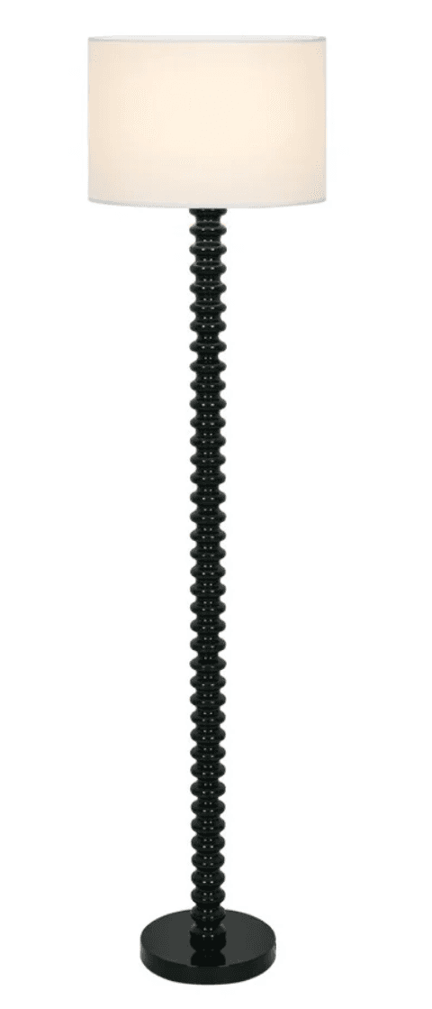 A contemporary floor lamp featuring a tall, slender stem composed of numerous glossy black spherical beads, culminating in a simple, cylindrical white drum shade. The lamp stands on a matching round, flat black base. — 3D model