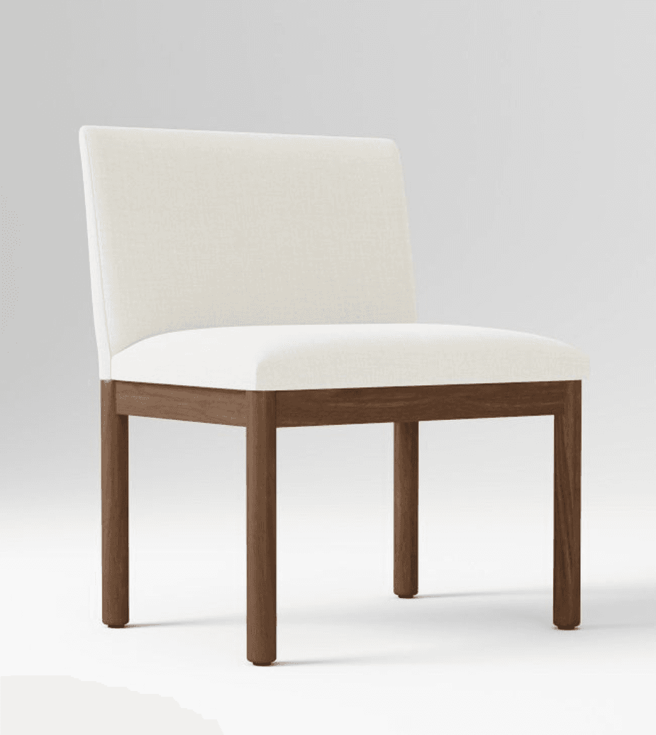 An armless dining chair featuring an upholstered seat and backrest in a light, neutral fabric, supported by a solid wood frame with straight, square-profile legs. — 3D model