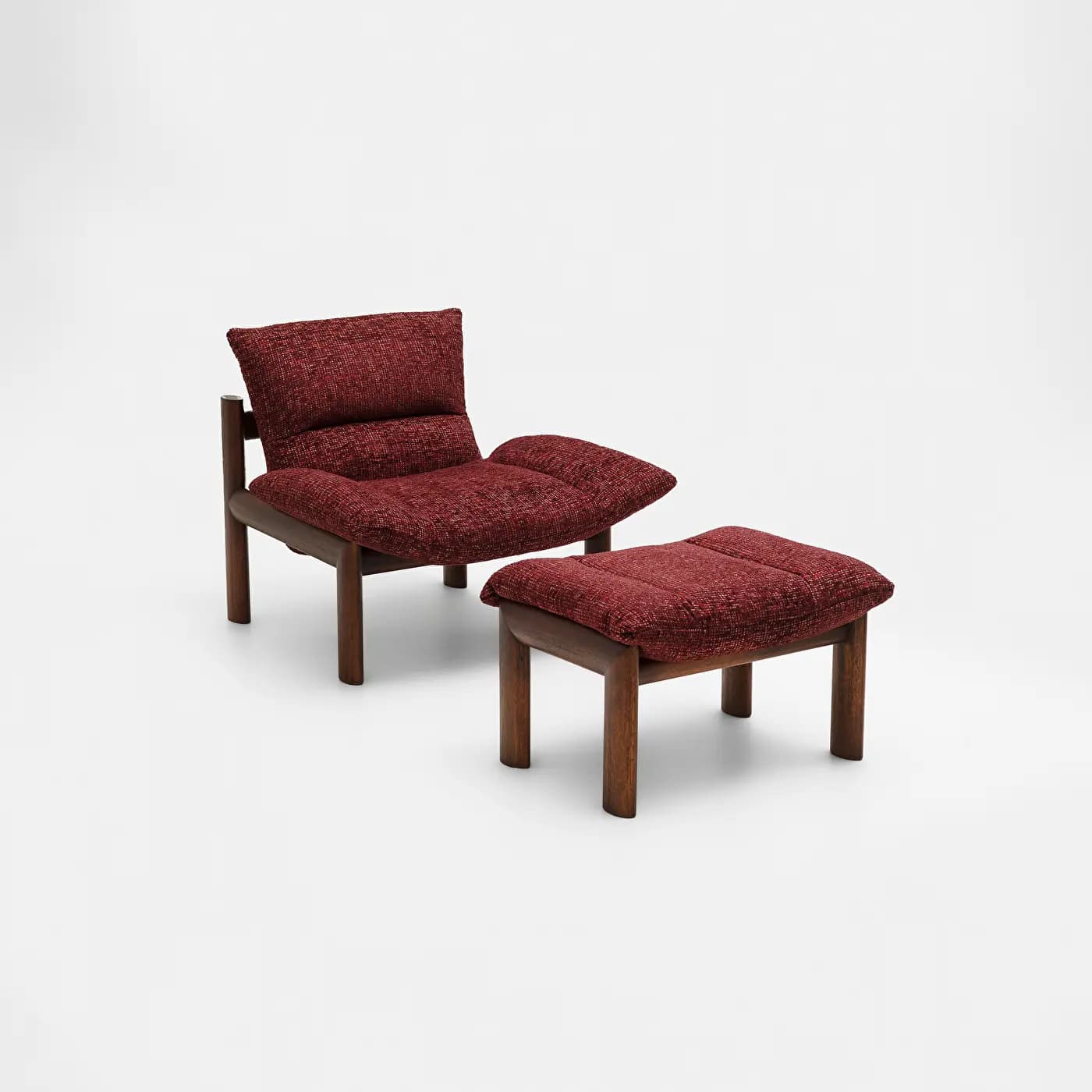 A two-piece seating set consisting of a lounge chair and a matching ottoman. Both feature sturdy dark wood frames and are upholstered in a rich, textured deep red fabric. The lounge chair has a low profile with a separate back cushion and an integrated, slightly sloped seat cushion. The ottoman is a simple rectangular block with a matching cushion. — 3D model