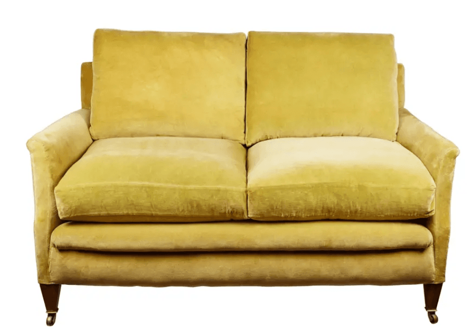 A two-seater sofa upholstered in a plush, velvety fabric. It features a straight back with two distinct cushions and a separate seat cushion. The arms are slightly rounded and curve gently downwards. The sofa is supported by four short, wooden legs, with the front legs having visible casters for mobility. The overall design suggests a classic or traditional style. — 3D model