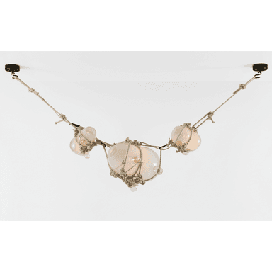 A multi-pendant lighting fixture featuring several glass globes, some clear and some frosted, encased in hand-tied natural fiber rope netting. These individual light elements are suspended horizontally by additional lengths of rope, which are then attached to dark-finished ceiling mounts on either end. The design evokes a nautical or organic aesthetic. — 3D model (AI enhanced source)