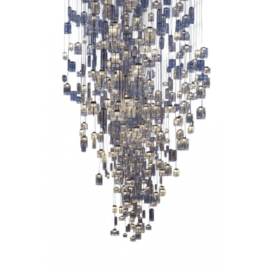 A grand, multi-tiered chandelier featuring numerous individual lighting elements suspended at varying heights to create a dramatic cascading effect. Each element consists of a rectangular block of textured or molded glass, appearing in shades of clear, blue, and amber, encasing an internal light source. The overall form tapers downwards, presenting a dynamic and luxurious illuminated sculpture. — 3D model (AI enhanced source)