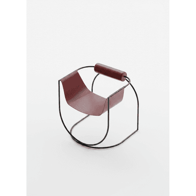A contemporary rocking lounge chair featuring a continuous black tubular metal frame and a deep, burgundy leather sling seat. The frame forms the rocking base and supports a single cylindrical leather-wrapped armrest. — 3D model (AI enhanced source)