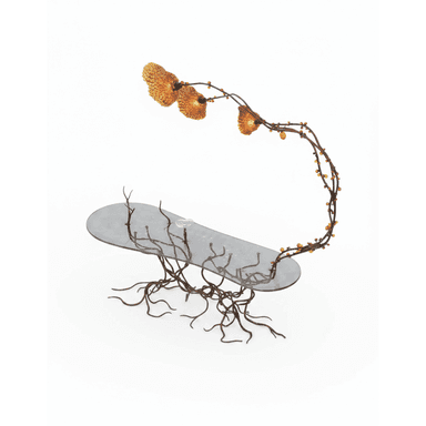 A highly sculptural coffee table featuring an elongated, oval-shaped glass top and a patinated metal base sculpted to resemble intertwined roots. An integrated light fixture, designed as an arching branch with three organic, textured shades and amber glass beads, extends from the base over the tabletop. — 3D model (AI enhanced source)
