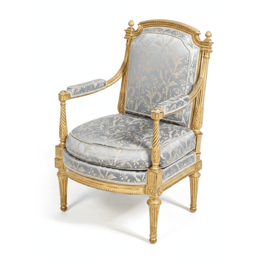 An ornate Louis XVI style armchair featuring an extensively gilded and carved wooden frame, upholstered in a light blue-gray brocade fabric with a gold floral pattern. It has a high, rounded back, padded armrests, fluted tapered legs, and decorative finials. — 3D model (AI enhanced source)