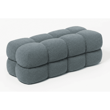 A contemporary, rectangular bench featuring deeply tufted, rounded segments upholstered in a textured, slate-blue fabric. The design emphasizes soft, pillowy forms with a modular aesthetic. — 3D model (AI enhanced source)