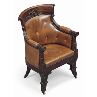 A classical armchair with a curved, tufted leather seat and back, upholstered with brass tack detailing. The wooden frame is dark stained and features carved decorative elements on the crest rail, armrests, and legs. The chair is supported by four carved legs, two of which have brass casters. — 3D model (AI enhanced source)