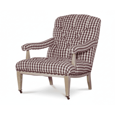 A traditional upholstered armchair featuring a maroon and white gingham check pattern. The backrest and seat are deeply tufted, providing a classic, cushioned appearance. The armrests are also upholstered and gently rolled, supported by exposed light-toned wooden stiles. The chair's frame includes visible wooden legs, with the front legs equipped with brass casters for mobility. Decorative brass nailhead trim outlines the base of the seat where the fabric meets the wooden frame. — 3D model (AI enhanced source)