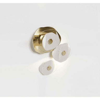 A modern wall-mounted lighting fixture featuring a layered design. The fixture consists of several organic, undulating shapes in polished gold-toned metal, overlaid with translucent white acrylic or glass elements, each centered with a smaller gold disc. The light emanates from behind or through these elements, creating a soft, diffused glow. — 3D model (AI enhanced source)